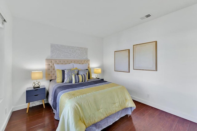 bedroom with dark hardwood / wood-style flooring