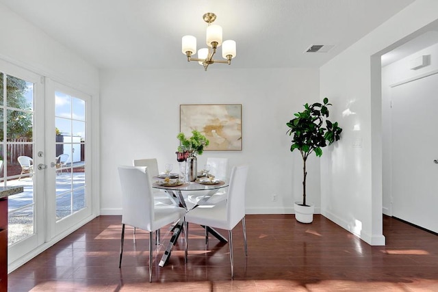 dining space with an inviting chandelier and dark hardwood / wood-style flooring