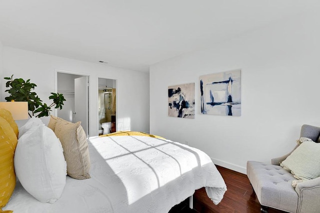 bedroom featuring dark wood-type flooring and connected bathroom