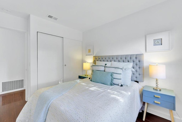 bedroom featuring dark hardwood / wood-style floors and a closet