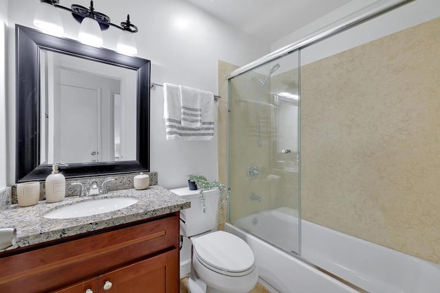 full bathroom featuring enclosed tub / shower combo, vanity, and toilet