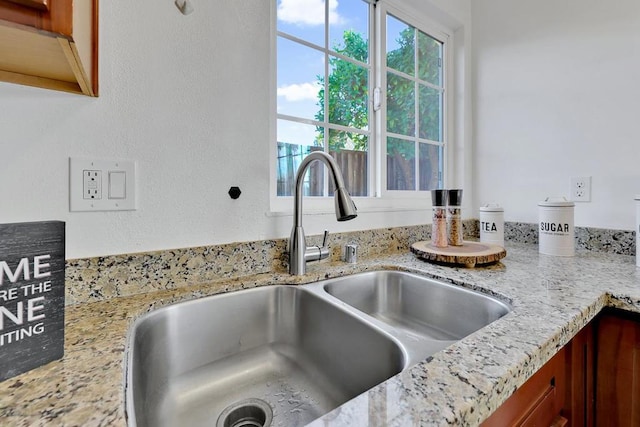 details with light stone countertops and sink