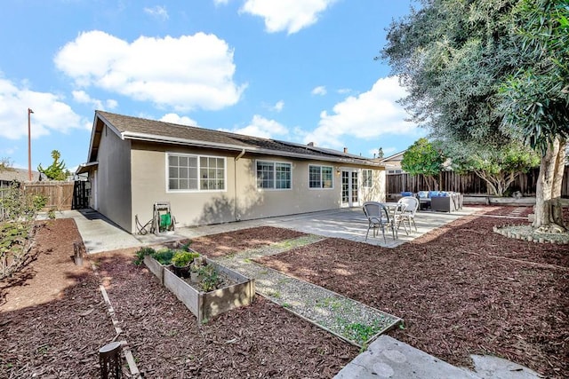 rear view of property featuring a patio