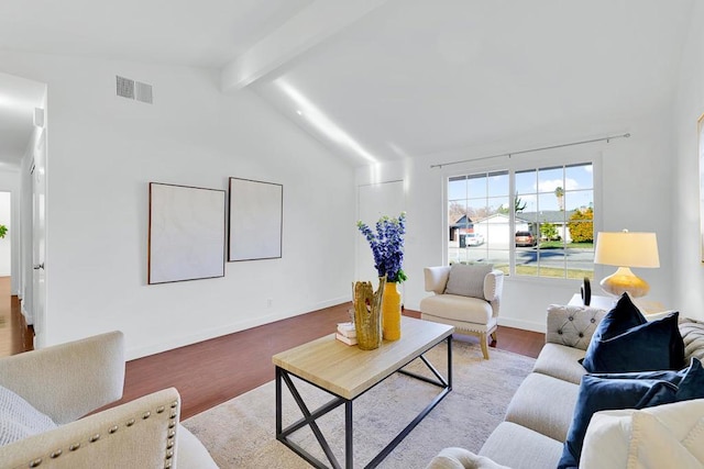 living room with vaulted ceiling with beams and light hardwood / wood-style floors