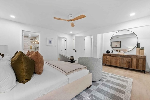 bedroom featuring ceiling fan, connected bathroom, and light hardwood / wood-style floors