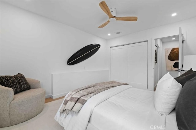 bedroom with ceiling fan, a closet, and light wood-type flooring