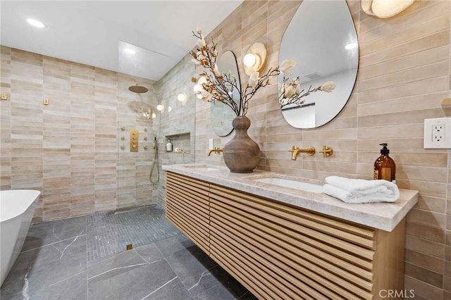 bathroom with independent shower and bath, vanity, and tile walls