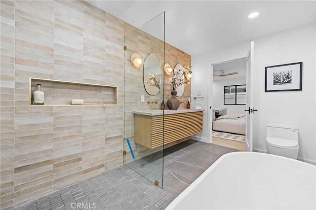 bathroom with vanity, toilet, tile patterned flooring, and a bathtub