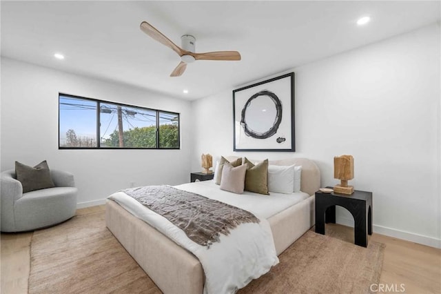 bedroom with ceiling fan and light wood-type flooring