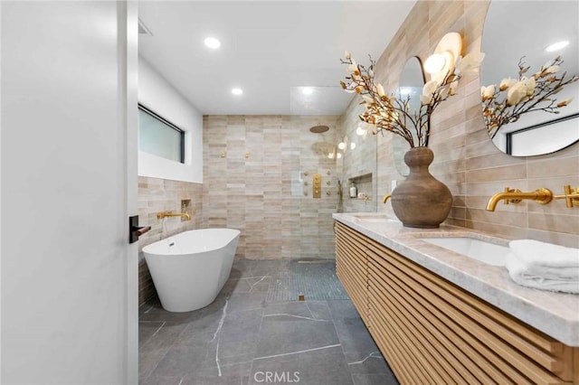 bathroom featuring vanity, separate shower and tub, and tile walls