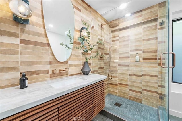 bathroom with tasteful backsplash, vanity, and walk in shower