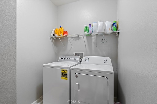 washroom with washing machine and clothes dryer