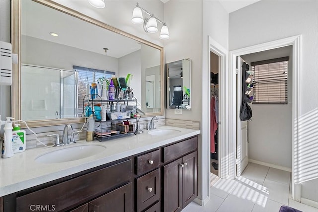 bathroom with vanity, a shower with door, and tile patterned floors