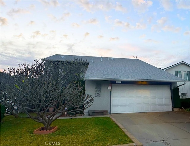 view of front of home with a garage and a front lawn