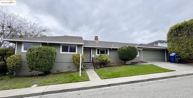 ranch-style home with a garage and a front lawn