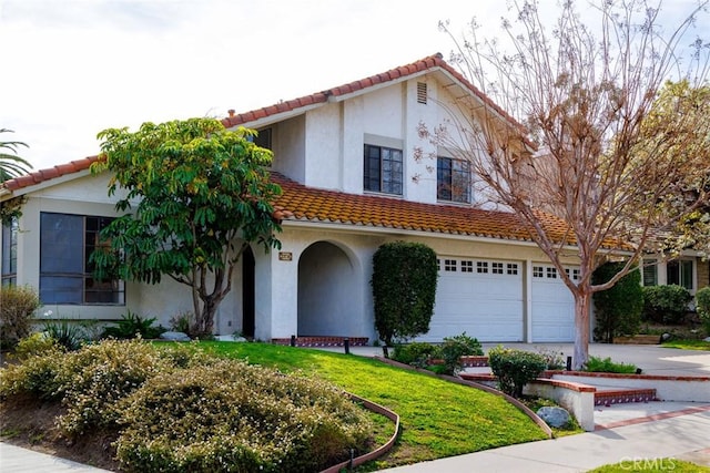 view of front of house with a garage and a front lawn