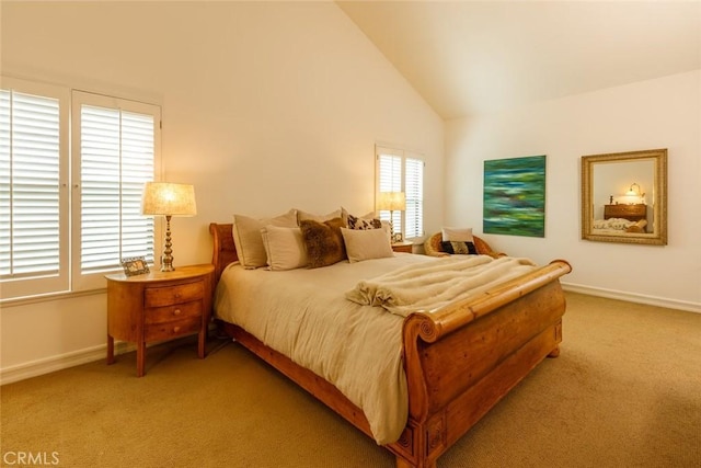 carpeted bedroom with high vaulted ceiling