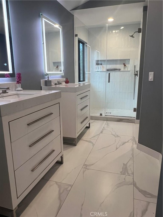 bathroom featuring vanity and a shower with door