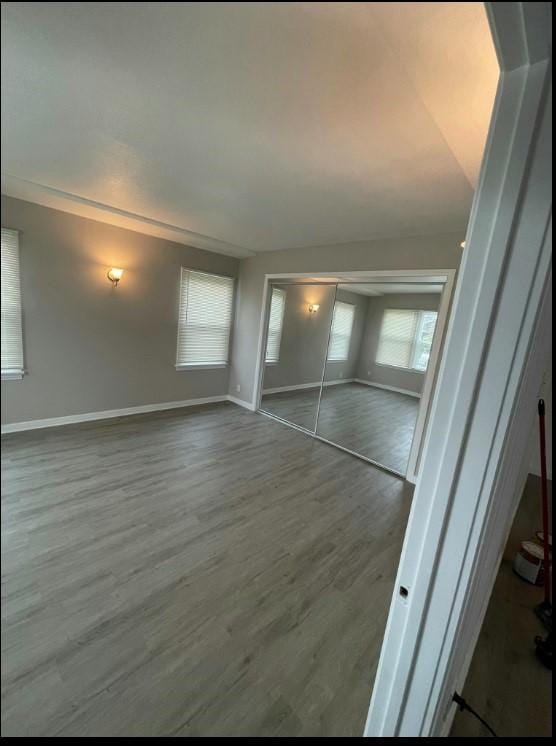 unfurnished bedroom featuring hardwood / wood-style floors and a closet