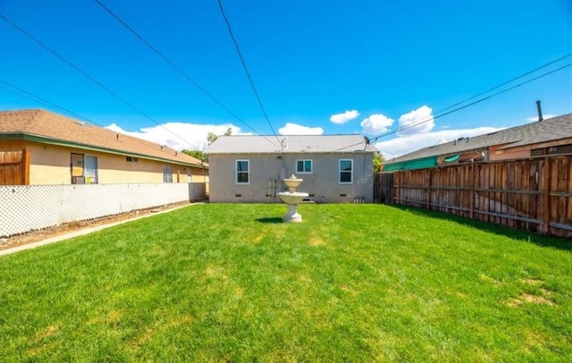 rear view of house featuring a yard