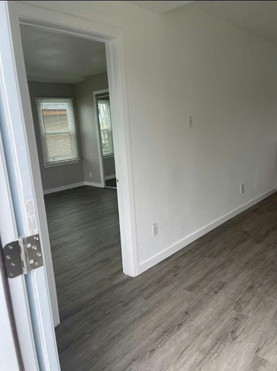 spare room with dark hardwood / wood-style flooring