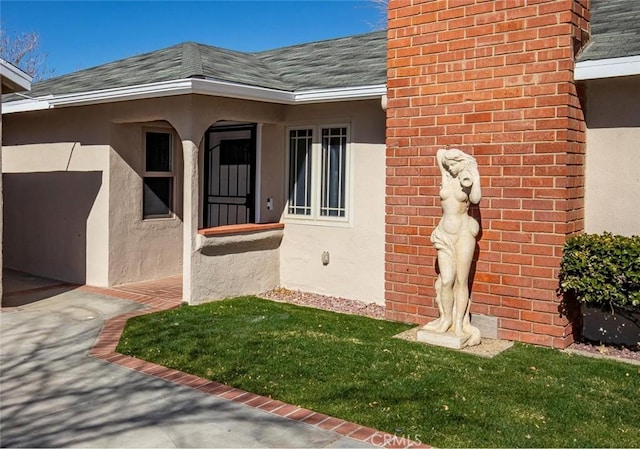 doorway to property featuring a lawn