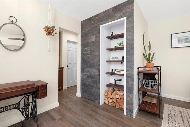 hallway featuring dark hardwood / wood-style flooring and built in features