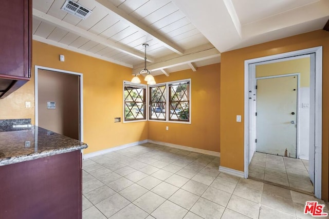 unfurnished dining area featuring light tile patterned flooring, wood ceiling, and beam ceiling