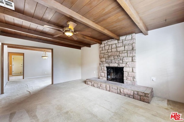 unfurnished living room featuring a fireplace, light colored carpet, ceiling fan, wooden ceiling, and beam ceiling