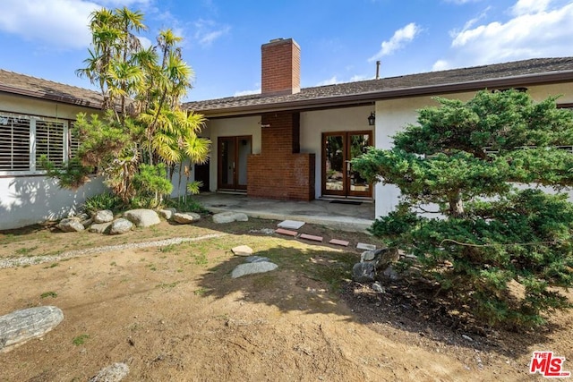 back of house featuring a patio and french doors