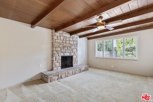 unfurnished living room with carpet flooring, a fireplace, beam ceiling, and wooden ceiling