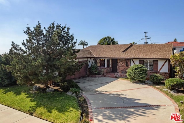 view of front facade with a garage and a front lawn