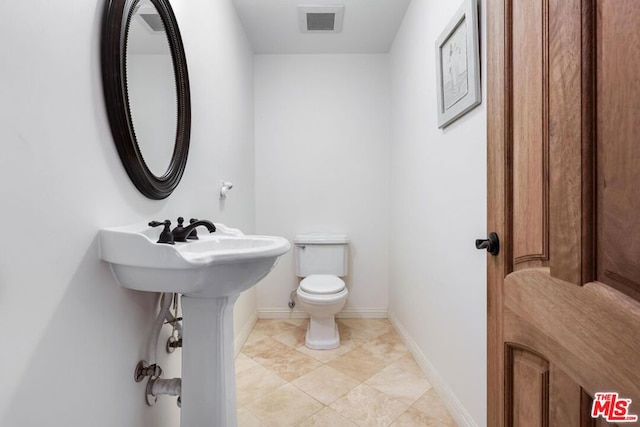 bathroom with tile patterned floors and toilet