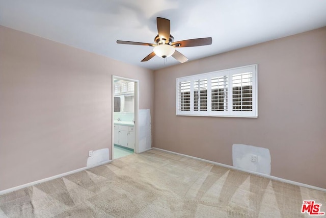 carpeted spare room with ceiling fan