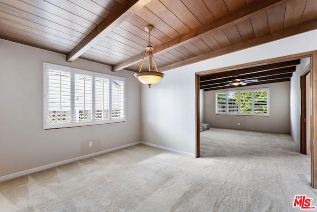 empty room with beamed ceiling, ceiling fan, carpet flooring, and wood ceiling