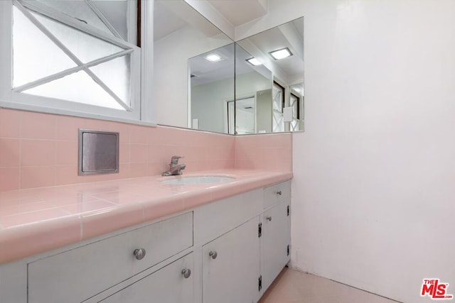 bathroom with vanity and decorative backsplash