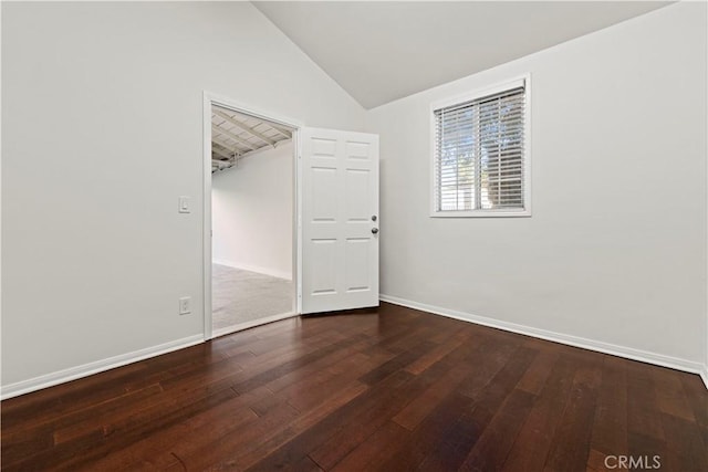 unfurnished room featuring hardwood / wood-style flooring and vaulted ceiling