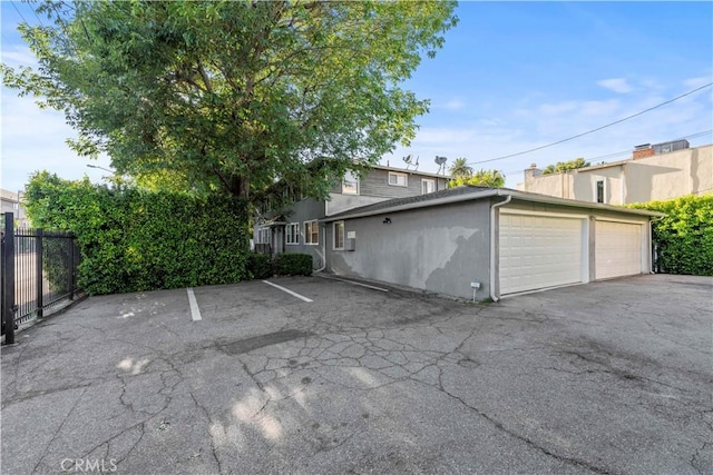 view of side of home featuring a garage