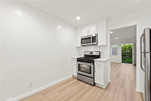 kitchen featuring white cabinetry, appliances with stainless steel finishes, and light wood-type flooring