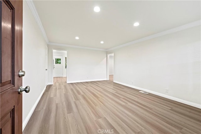 unfurnished room with crown molding and light hardwood / wood-style floors