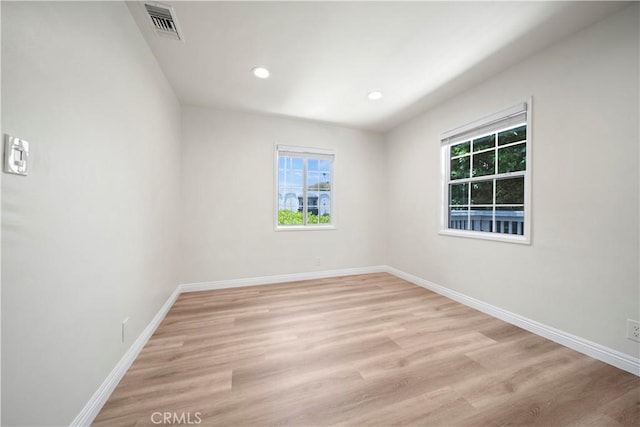 spare room featuring light wood-type flooring