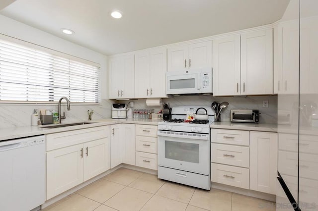 kitchen featuring white cabinetry, sink, and white appliances