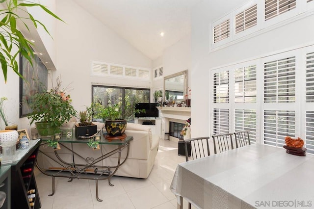 living room with light tile patterned floors and high vaulted ceiling