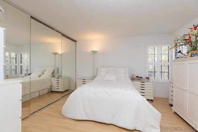 bedroom featuring a closet and light hardwood / wood-style flooring