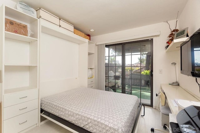 bedroom featuring access to exterior and light hardwood / wood-style flooring