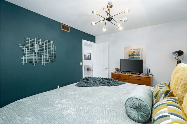 bedroom featuring an inviting chandelier