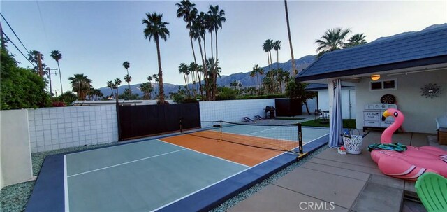 exterior space featuring a mountain view and basketball hoop