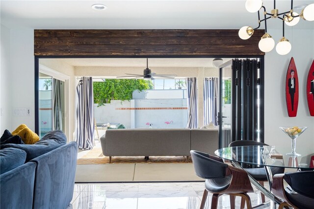 dining room featuring ceiling fan with notable chandelier