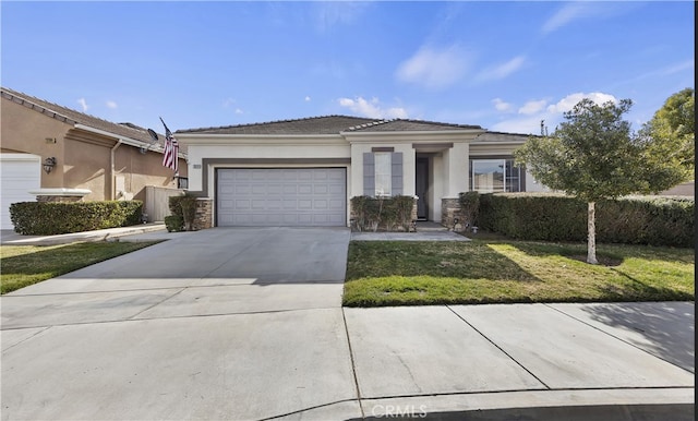 view of front of property with a garage and a front lawn