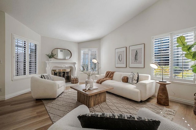 living room with vaulted ceiling and light hardwood / wood-style flooring